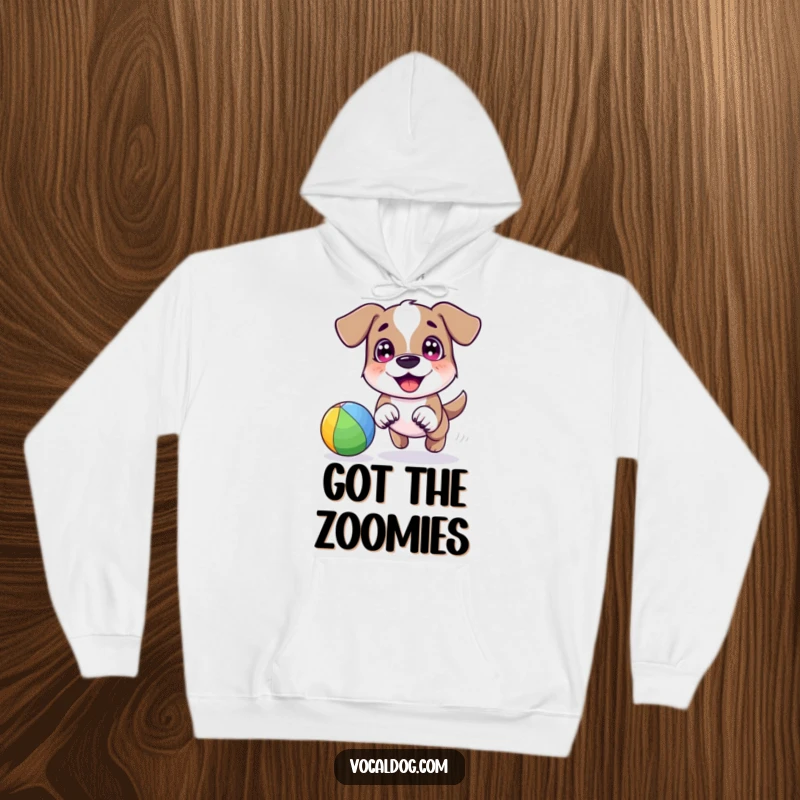 A happy dog character joyfully chasing a vibrant rainbow-colored ball with bright eyes, depicted on a cozy hoodie.